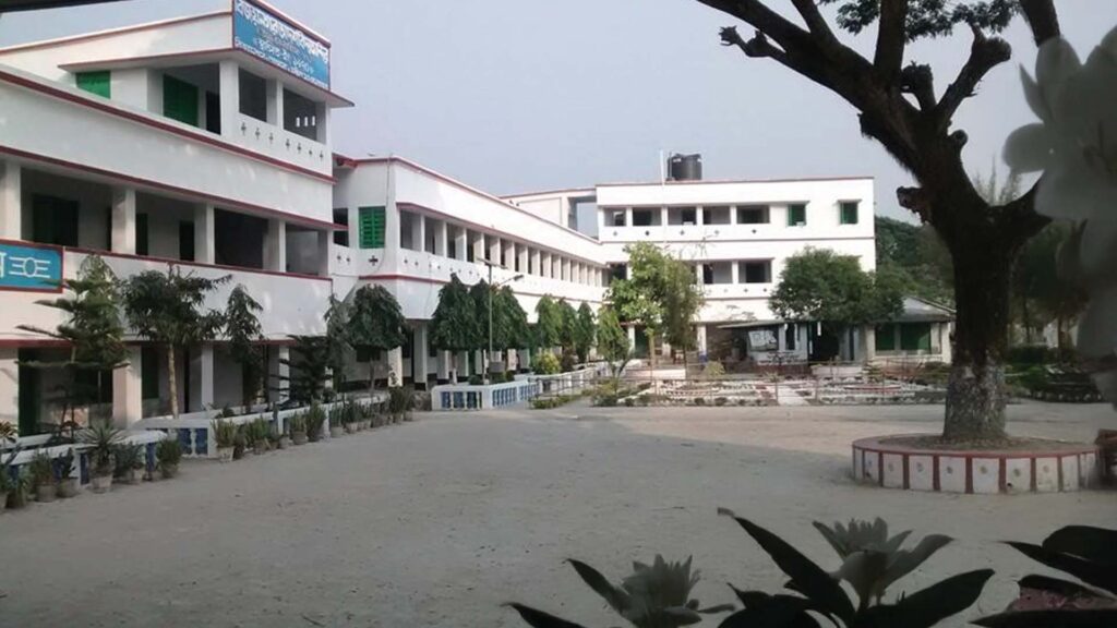 A clean and spacious courtyard inside Bijoynagar Adarsha Vidyamandir (H.S), surrounded by a well-maintained multi-story school building and greenery.