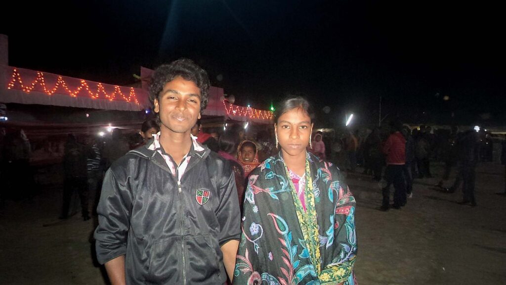 Asgar Molla with his sister Amina Molla during a night-time school or village event.
