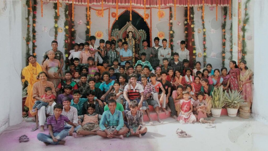 Group photo of students and villagers during Saraswati Puja celebration at Bijoynagar Adarsha Vidyamandir (H.S)