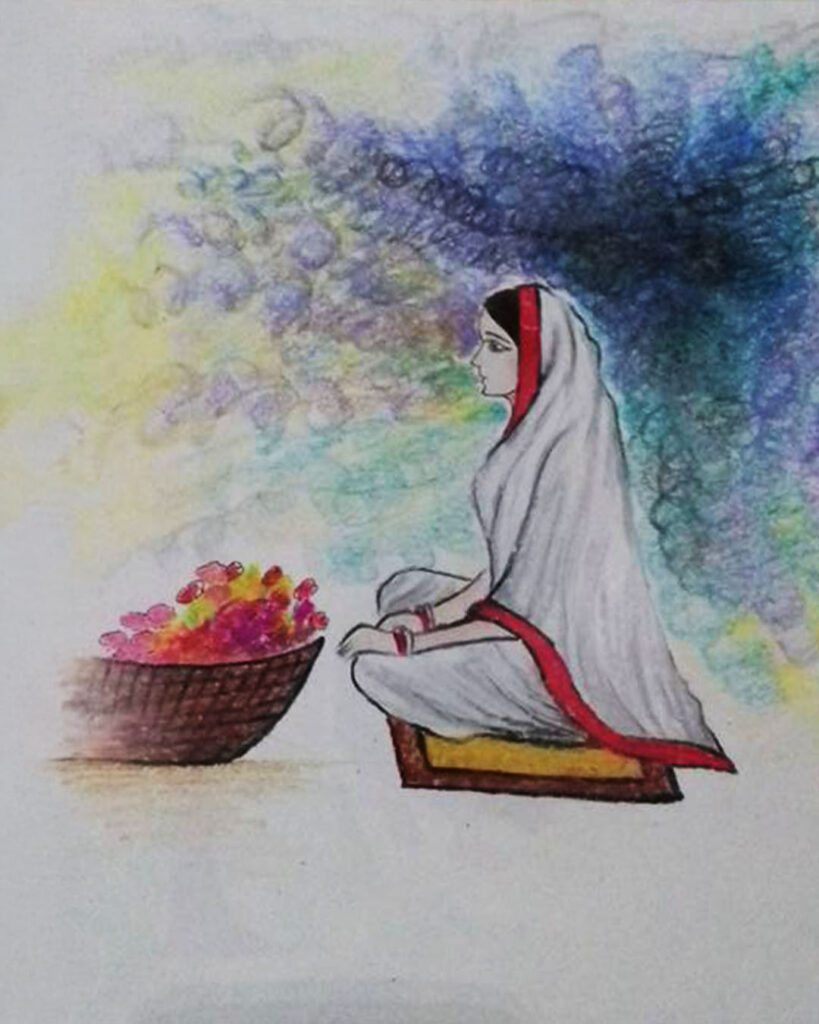 A woman in a white saree with a red border sits cross-legged on a cushion beside a basket of colorful flowers, with a dreamy, colorful background.