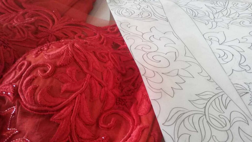 Floral khaka design and its embroidery result on red fabric created by Asgar Molla for boutique garments.