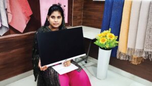 Tahamina Molla holding an Acer LED monitor for a custom-built graphic design PC