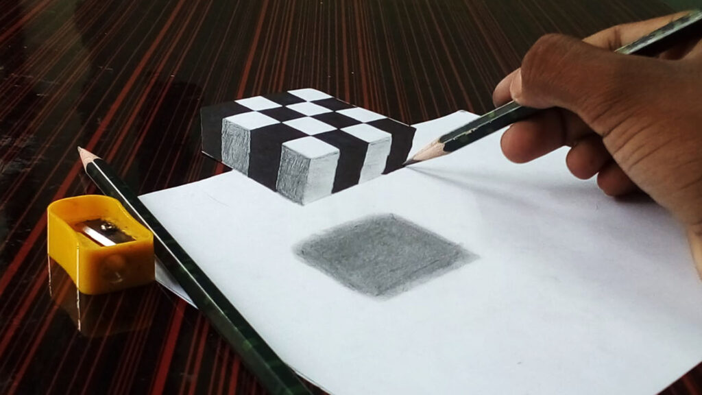Hand drawing 3D cube illusion with pencil on paper
