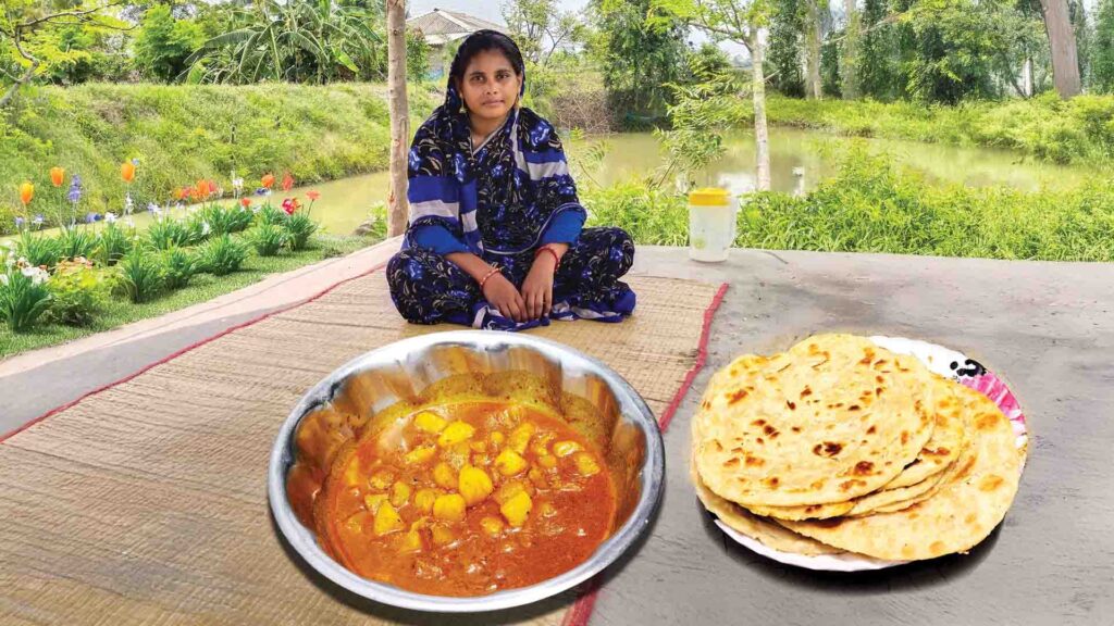Traditional Bengali breakfast with paratha and aloo dum served in a peaceful rural setting beside a pond.