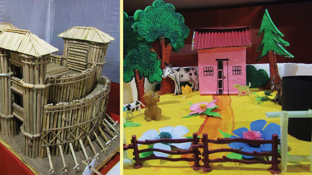 Handmade bamboo fort model and colorful village diorama with house, trees, cows, and flowers displayed at school exhibition.