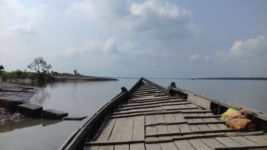 Wooden ferry boat crossing the Vidyadhari River at Bally Ferry Ghat in Sundarban, West Bengal, India.