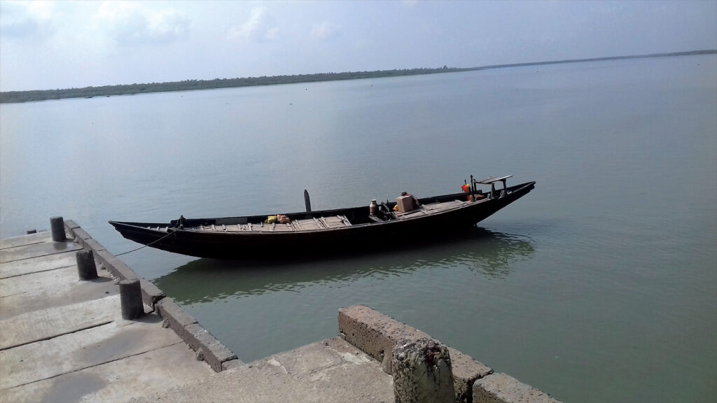 Wooden ferry boat docked at Bally Ferry Ghat on the Vidyadhari River in Sundarban, West Bengal.